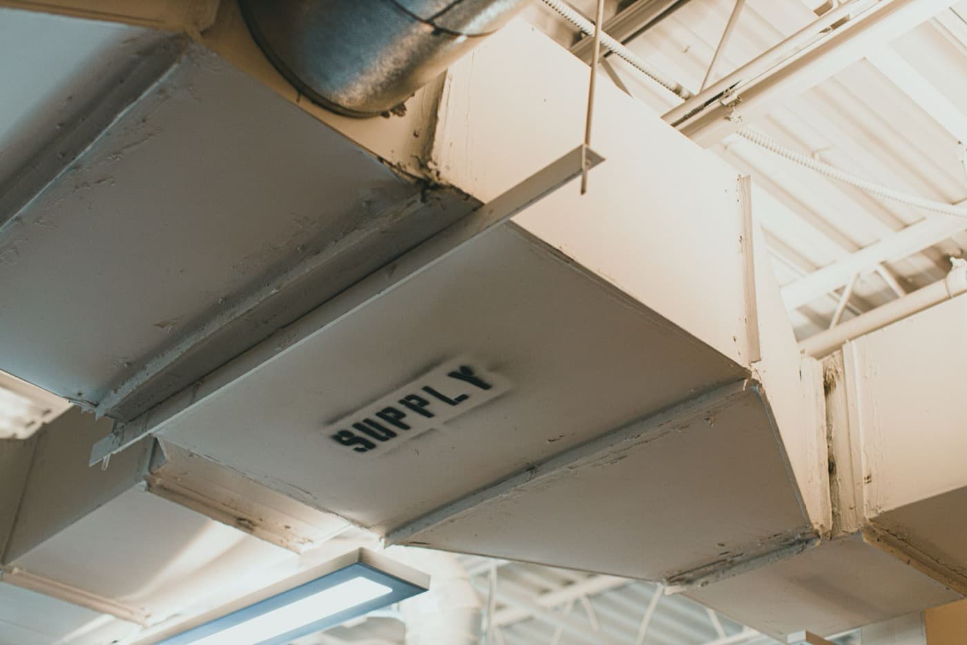 Sheet metal supply ductwork running through an unfinished ceiling